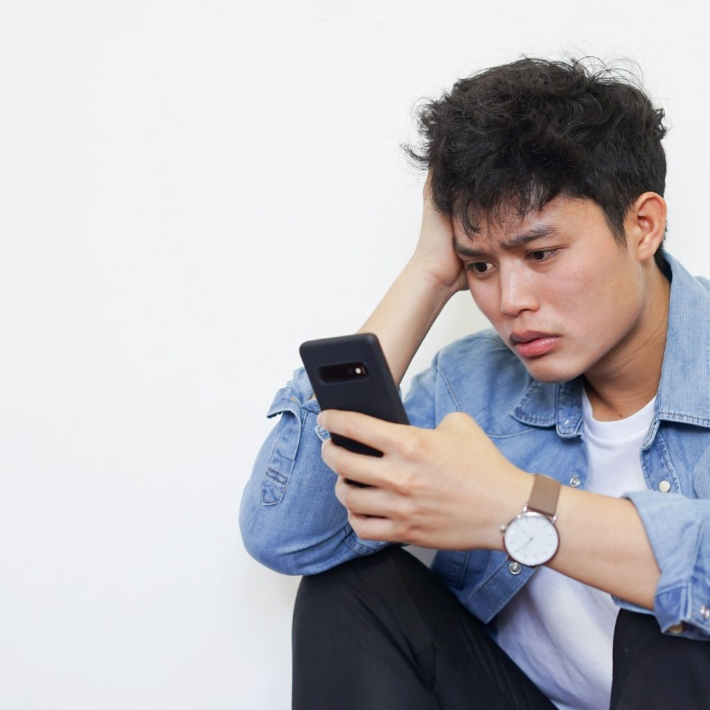 Confused business owner looking at a website on a mobile