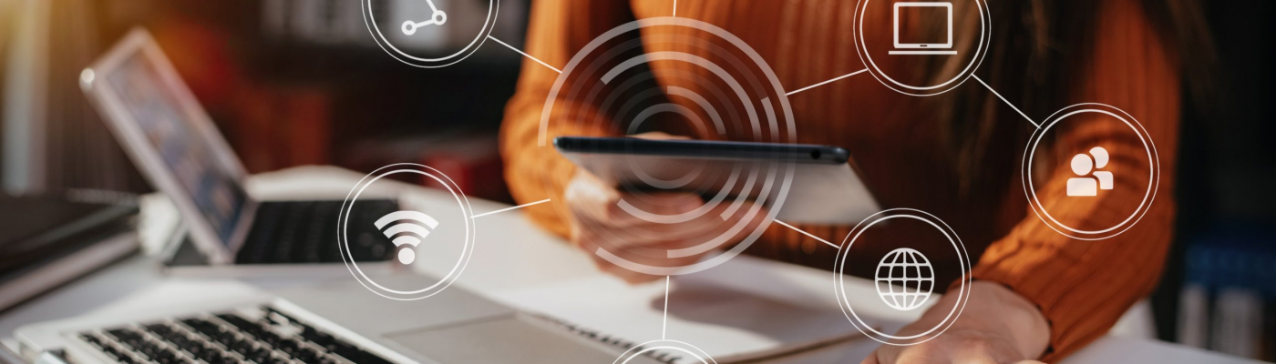 Small business owners collaborating with digital devices, representing a connected tech ecosystem